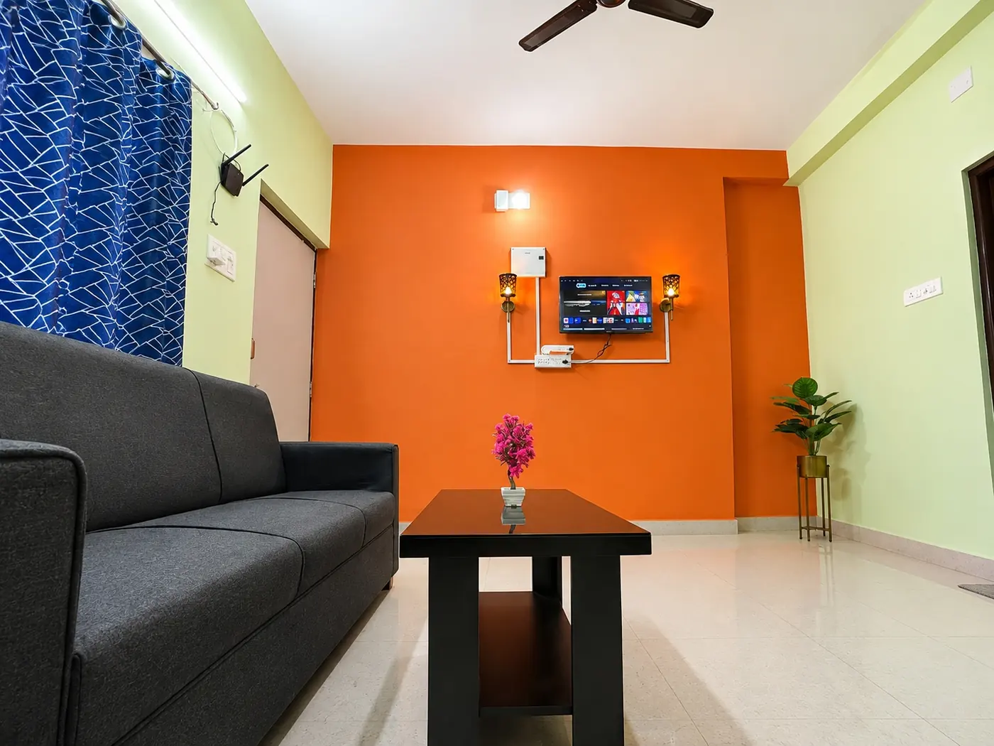 Living room with sofa and centre table at Yostel Mars