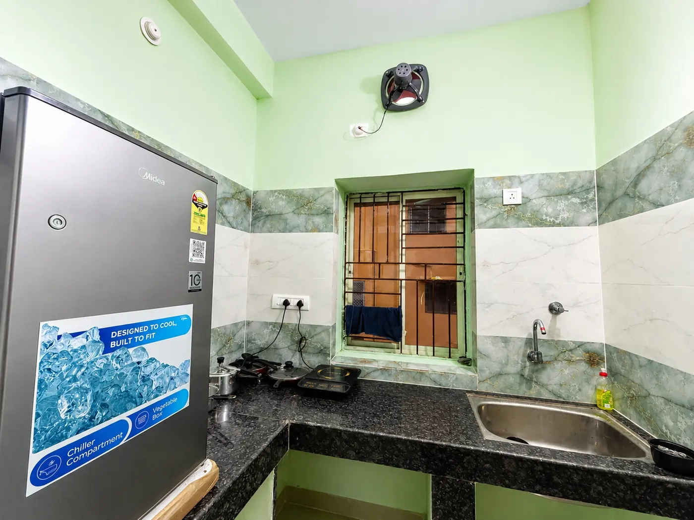 Kitchen with fridge and window at Yostel Mars