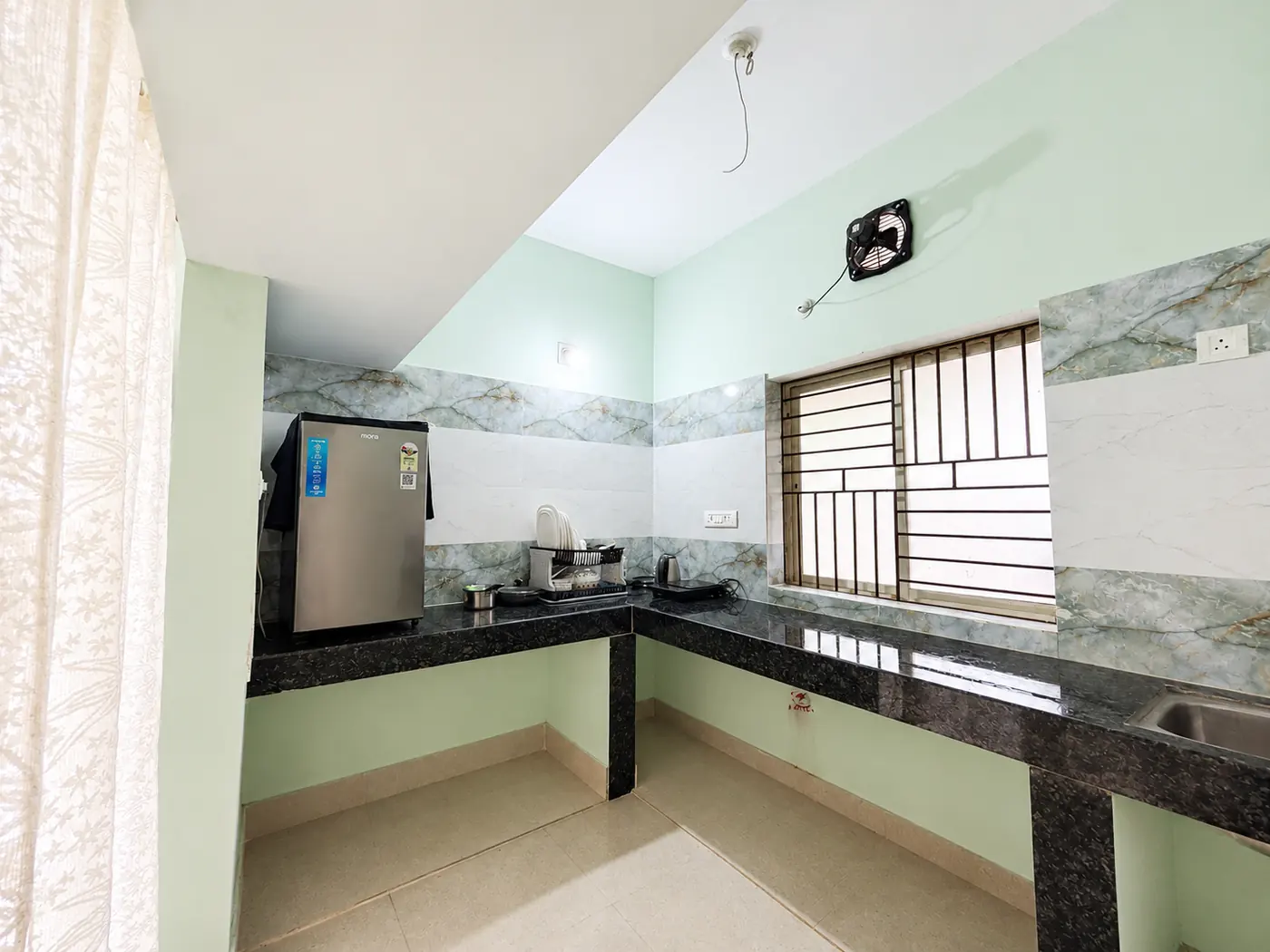 Kitchen with fridge and counter at Yostel Mercury