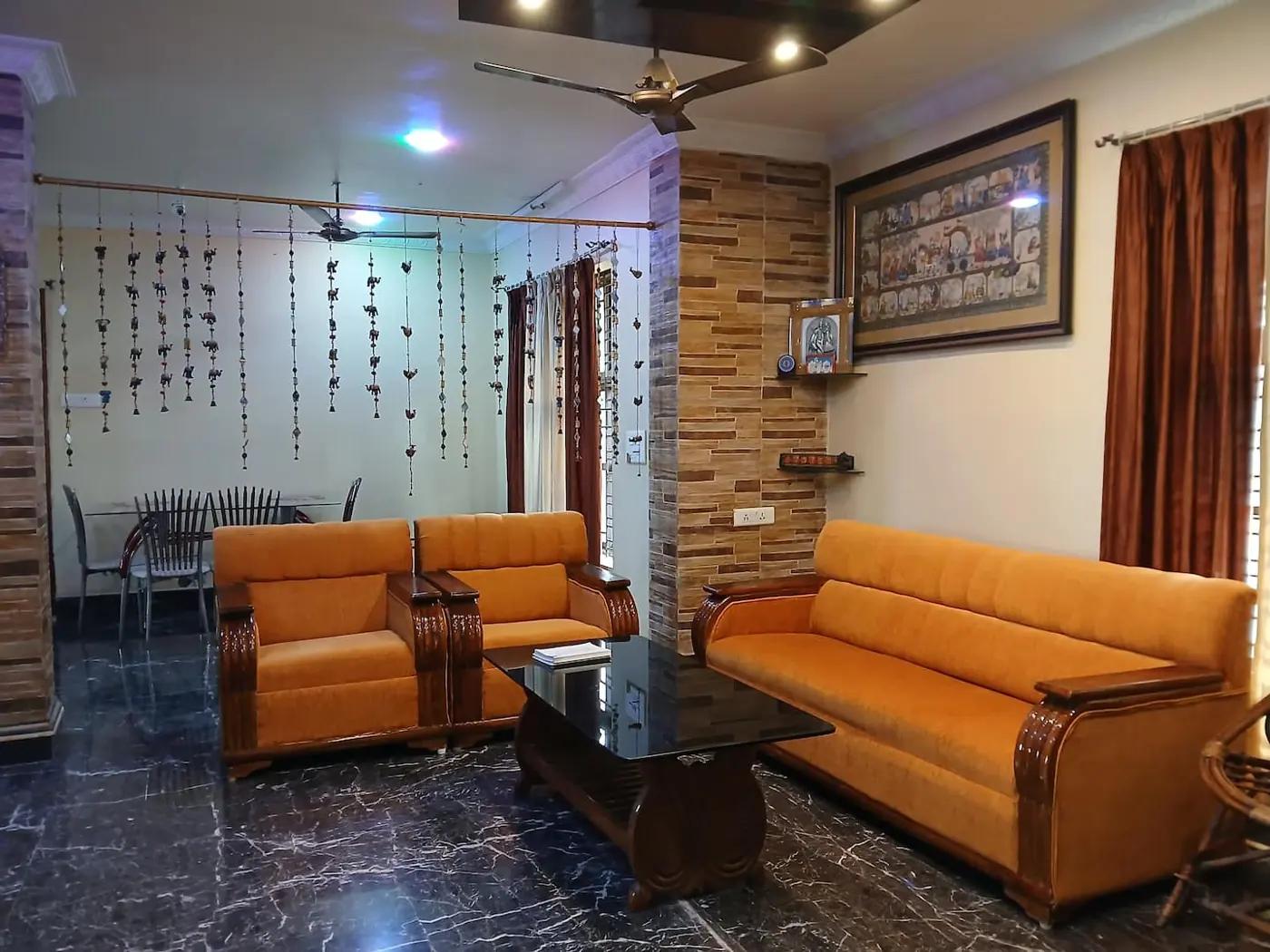 Living room with orange sofas and dining table at Yostel Patia